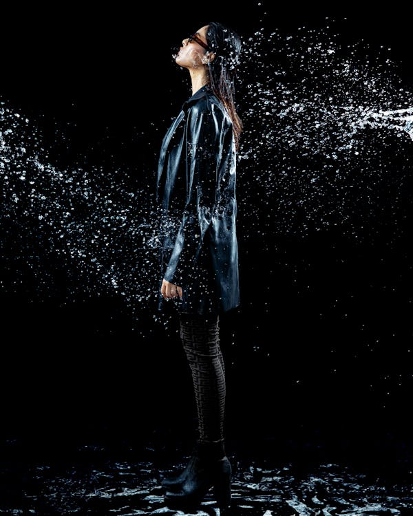 photo of women posing among splashing water