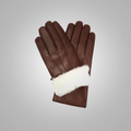Brown leather gloves with white fur lining on a gray background