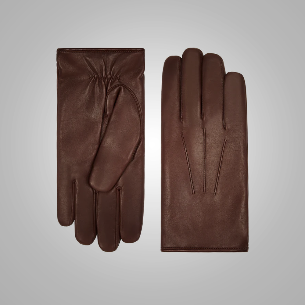 Pair of brown leather gloves on a light gray background