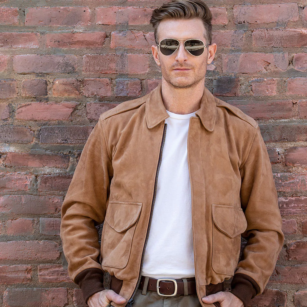 Man wearing an open light brown goatskin suede A-2 bomber jacket