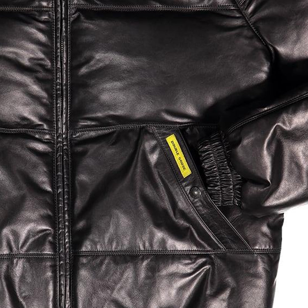 Close-up of a black quilted puffer jacket with a yellow brand label reading 'double goose' near the pocket, set against a plain white background.