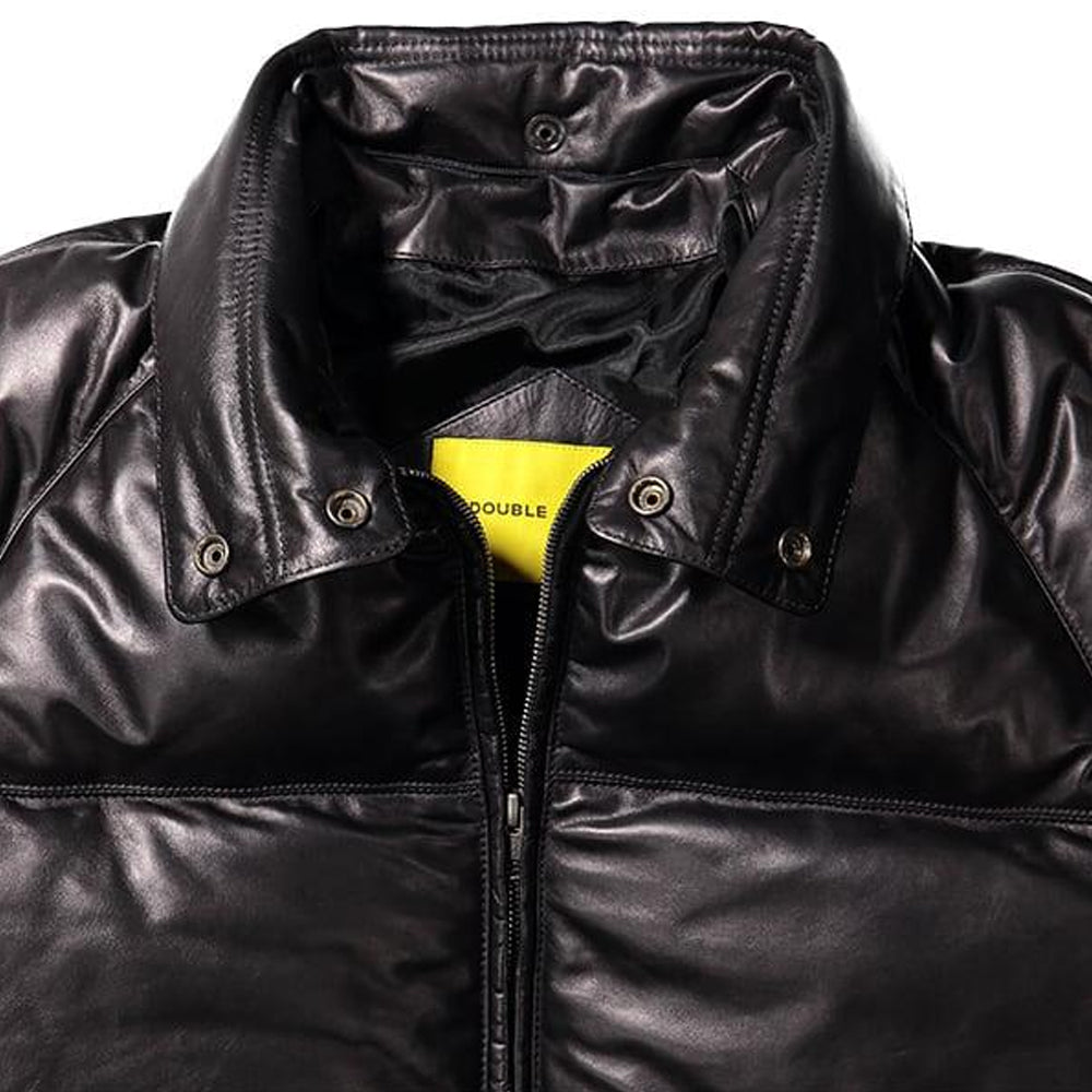 Close-up of a black leather jacket with a high collar, snap-button tabs, and a yellow brand label reading 'DOUBLE'.