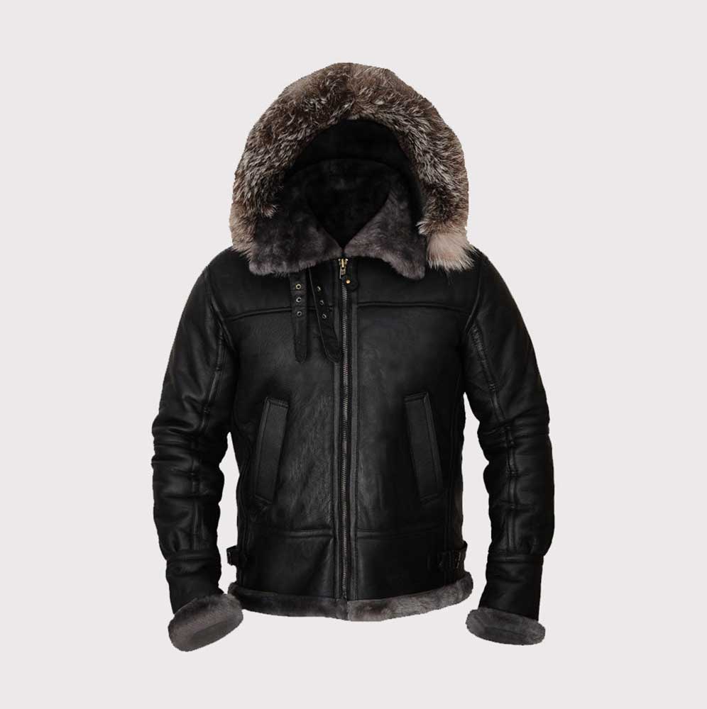 A black leather hooded jacket with a thick brown and gray fur trimmed hood, black leather body, zippered front, and ribbed cuffs and hem, shown on a light gray background.