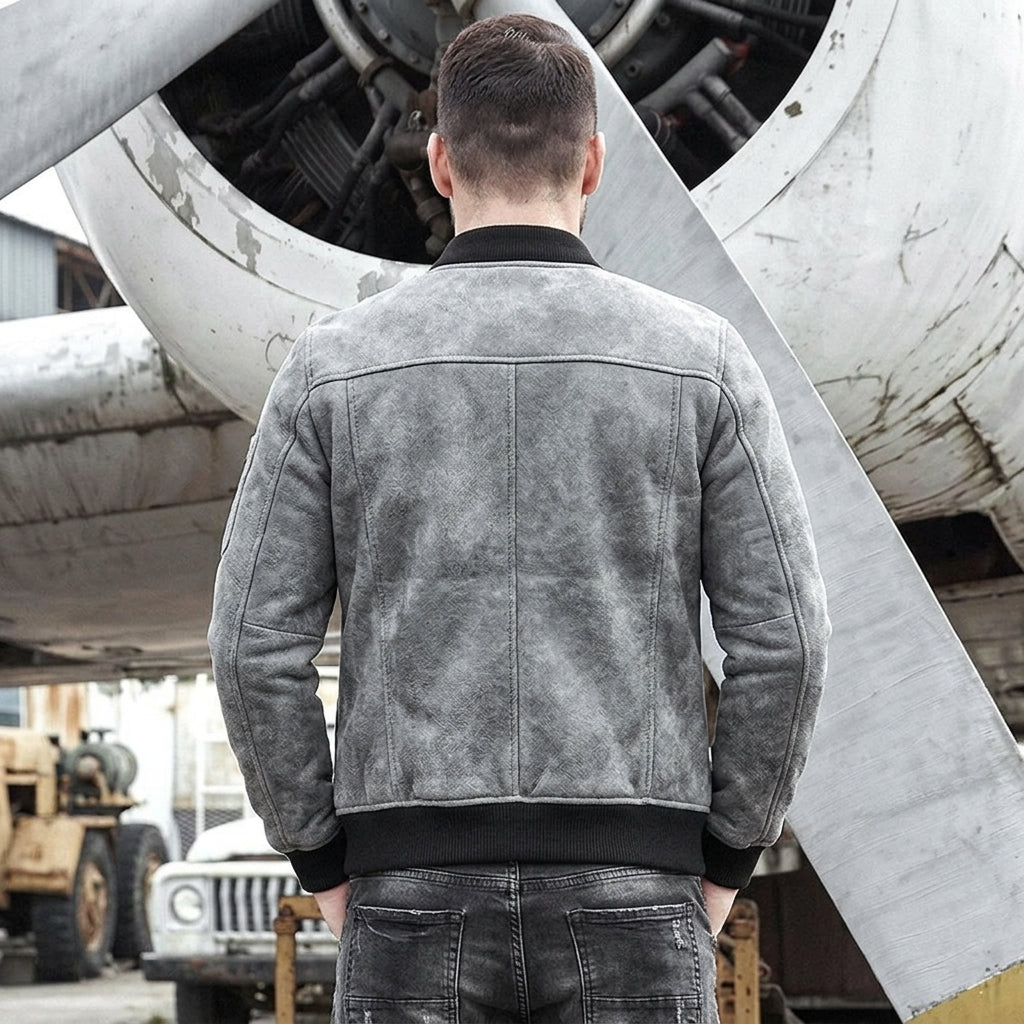 Back view of men’s grey shearling bomber with ribbed hem