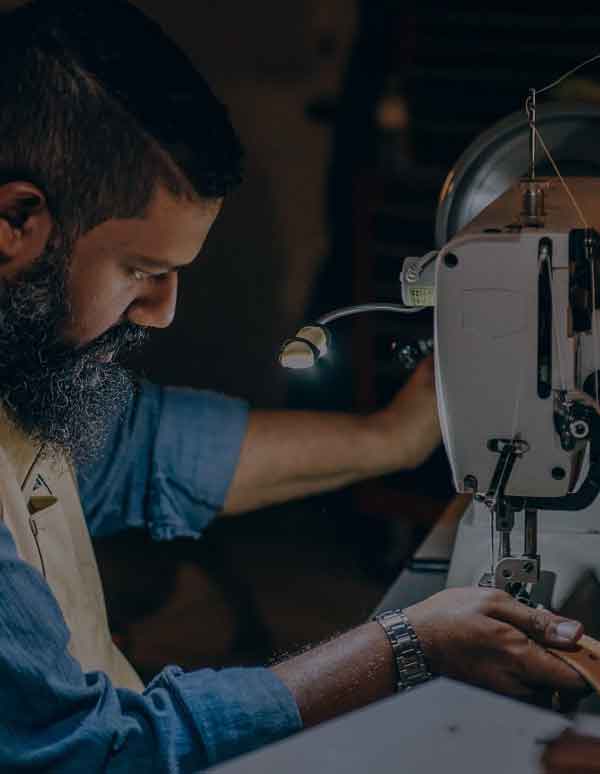 men checking the leather on machine