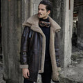 A man wearing a long brown shearling aviator fur coat with sheepskin leather and arm buckles.