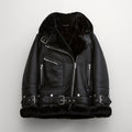 Black sheepskin shearling leather jacket with a standing collar, zippered front, and multiple belt straps.