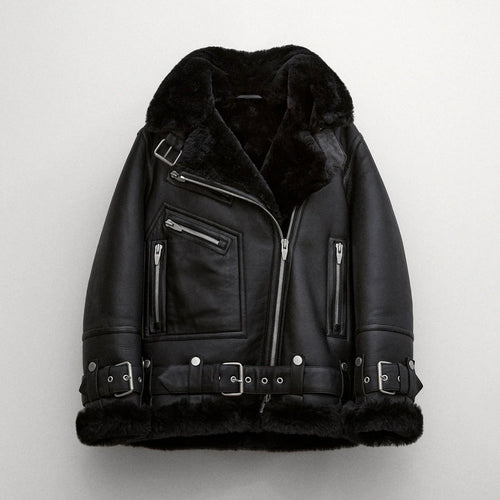 Black sheepskin shearling leather jacket with a standing collar, zippered front, and multiple belt straps.